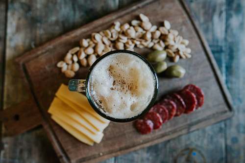 flat lay sliced cheese beside nuts foam
